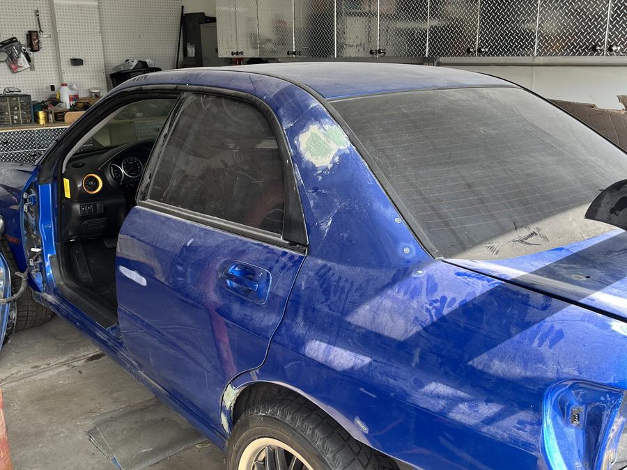 Body filler over the repaired quarter panel